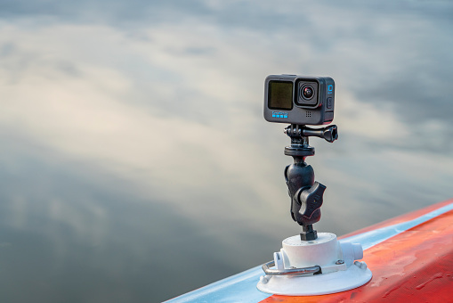 Fort Collins, CO, USA - October 7, 2021: GoPro Hero 10 waterproof action camera mounted with RAM mount and Seasucker suction cup on a deck of paddleboard or kayak.