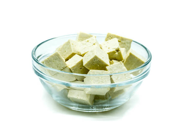 istock Tofu in glass bowl isolated on white background 1345713184