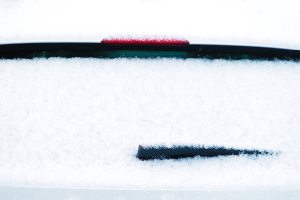 istock car windshield wiper in the snow. Winter 1345714700