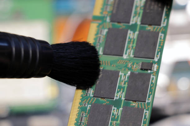 istock The service center worker cleans dust at Random Access Memory or electronic board RAM. 1345714875
