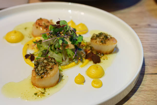 istock Woman eats scallops in a restaurant. 1345715826