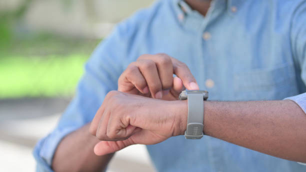 istock Close up of Young African Man using Smartwatch 1345716110