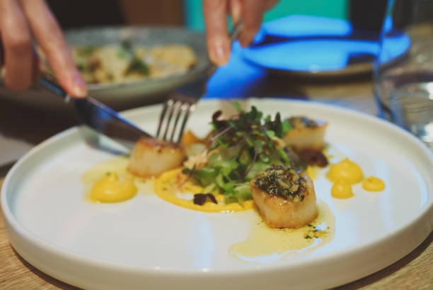 istock Woman eats scallops in a restaurant. 1345716163