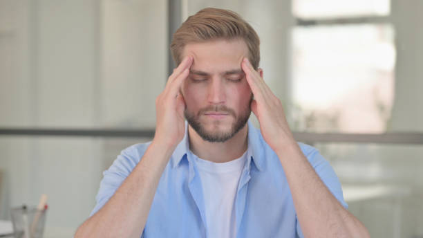 istock Portrait of Young Creative Man having Headache 1345717085