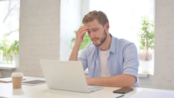 istock Young Creative Man with Laptop having Loss, Failure 1345718782