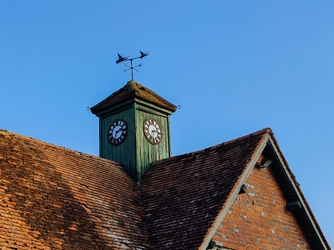 Clock tower and weather vain on roof
