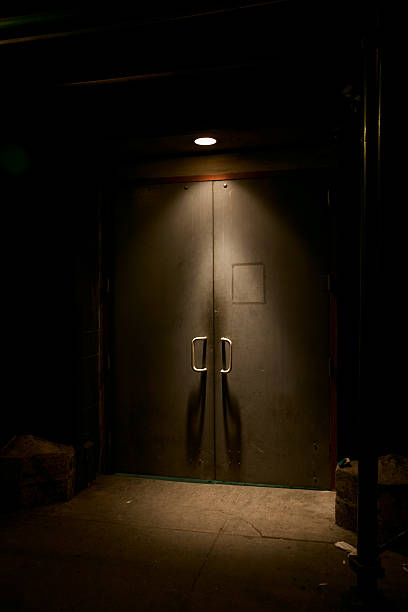 istock Set of Closed Doors Illuminated by an Overhead Spotlight 134572137