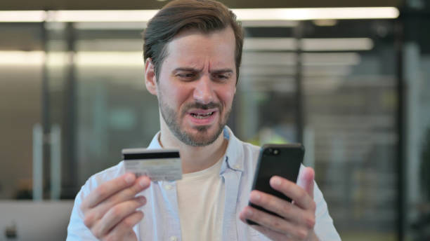 istock Casual Young Man Doing Online Payment on Smartphone 1345722237