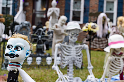 Family decorates their yard with a graveyard, clever skeletons and a dollhead fence in Virginia Beach, Virginia