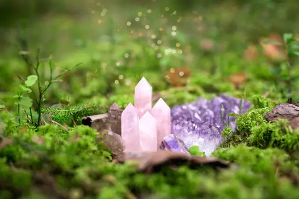 Natural crystal gemstones in magic forest, minerals on green moss, self-discovery and mental healing concept