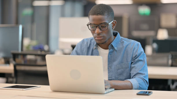 istock African American Man Working on Laptop in Office 1345724515