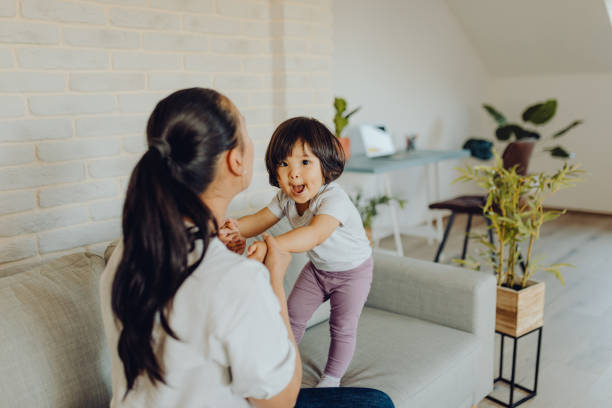 istock Mother and daughter playing with blocks on the floor 1345726204