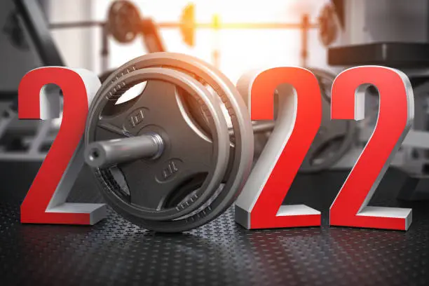 Photo of 2022 Happy New Year  in fitness bodybuilding workout gym. Number 2022 with barbell and oter spoirt equipment.