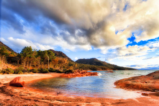 Tas Honeymoon bay round Local round Honeymoon bay on Coles bay in Tasmania - Freycinet peninsula. Scenic seascape in soft sunset light. honeymoon bay stock pictures, royalty-free photos & images