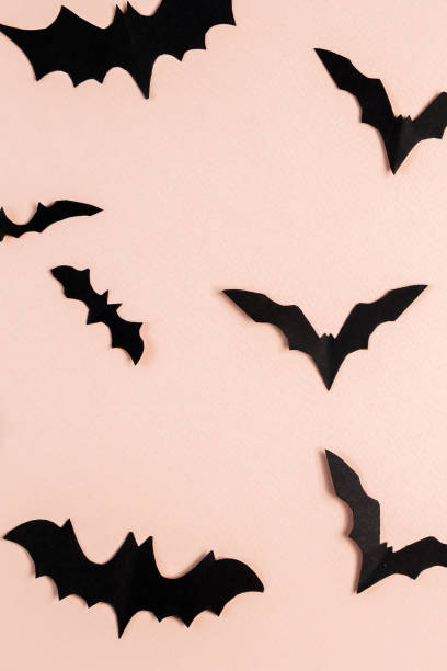istock Halloween concept. Bats and spiders on pink background. Festive decorations. 1345740394
