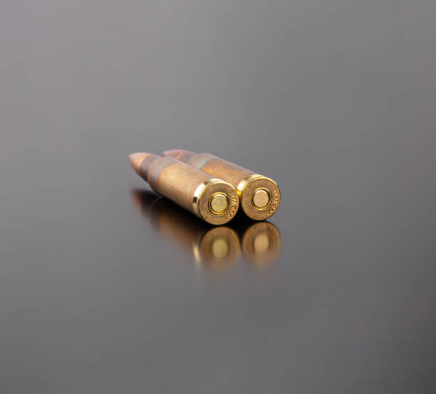 istock Bullet isolated on black background with reflexion. Rifle bullets close-up on black back. Cartridges for rifle and carbine on a black. 1345740659
