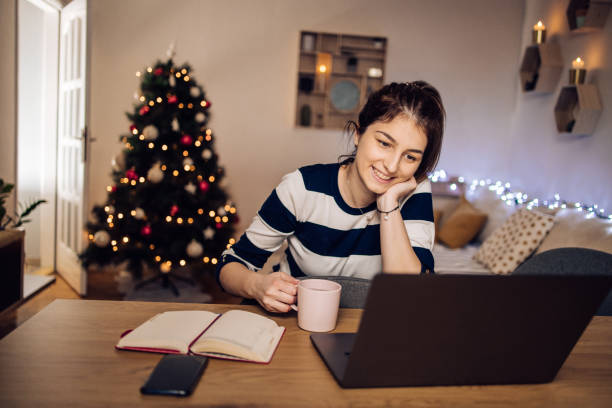 istock Young freelancer spending Christmas Eve online after work 1345741383