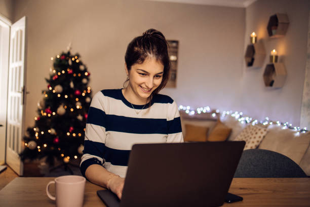 istock Girl having fun online for Christmas Eve 1345741464