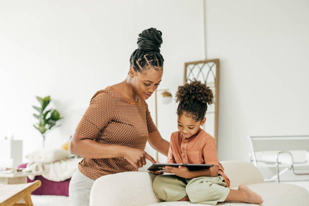 istock Mom and daughter watching video online 1345741632