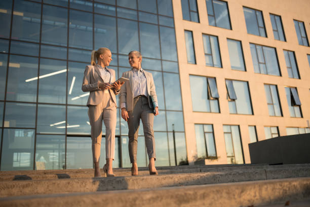 istock Elegant colleagues sharing ideas outdoors. 1345746819