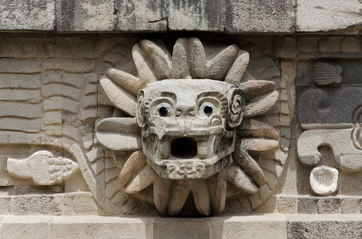 Feathered Serpent stone head in the Temple of Quetzalcoatl in Teotihuacan, a prehispanic Mesoamerican city located in the Valley of Mexico