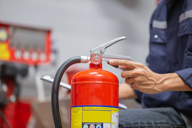 istock Engineer are checking and inspection a fire extinguishers tank in the fire control room for safety training and fire prevention. 1345765491