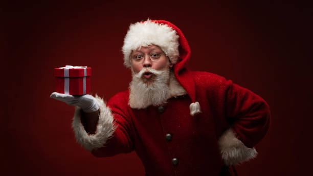 istock Santa Claus with gift box 1345765627