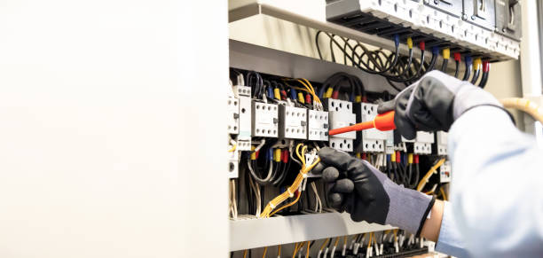 Electricians work to connect electric wires in the system, switchboard, electrical system in Control cabinet. Electricians work to connect electric wires in the system, switchboard, electrical system in Control cabinet. installation art stock pictures, royalty-free photos & images