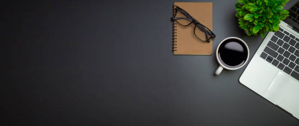 istock Workspace - Flat top view illustration of a workspace with a coffee cup and notebook on the black desk surface,Office desk concept. 1345765731