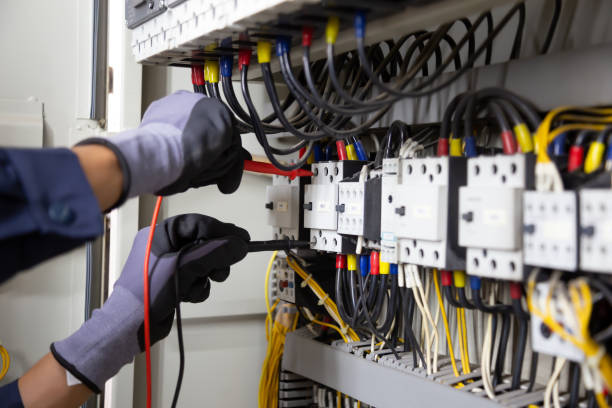 istock Electrician engineer tests electrical installations and wires on relay protection system. Adjustment of scheme of automation and control of electrical equipment. 1345765736