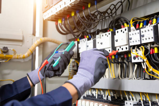 istock Electrician engineer tests electrical installations and wires on relay protection system. Adjustment of scheme of automation and control of electrical equipment. 1345765741