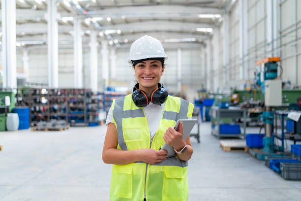 Portrait Of Female Engineer At Factory Portrait Of Female Engineer At Factory ear protectors stock pictures, royalty-free photos & images