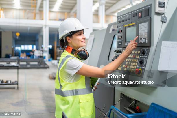 Female Engineer Programming A Cnc Machine At Factory Stock Photo - Download Image Now