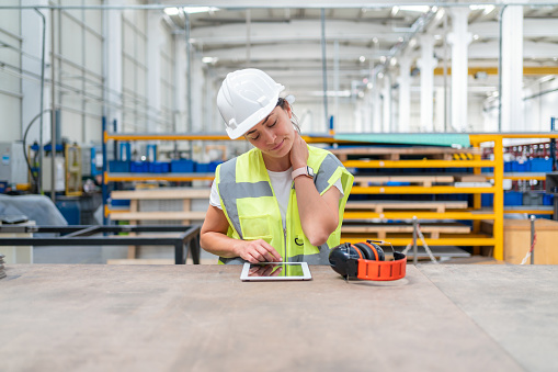 Female Engineer Working With Digital Tablet At Factory