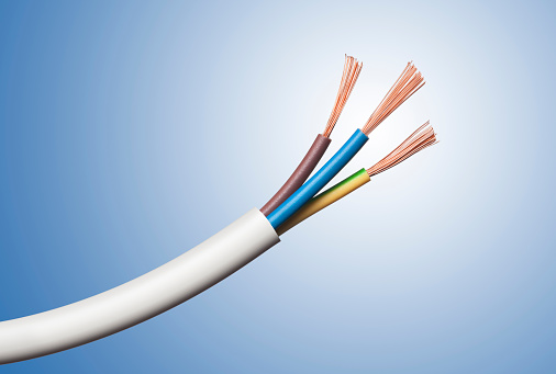 Electrical power cable isolated on blue background.