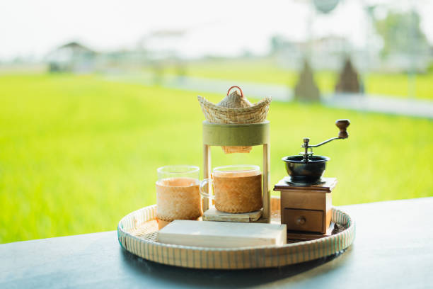 istock Small retro coffee drip set with rice field background 1345769816