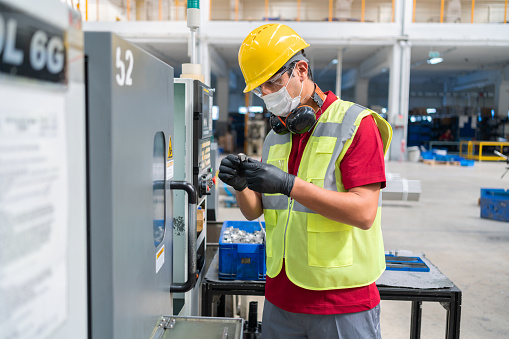 Factory Worker Programming A CNC Machine