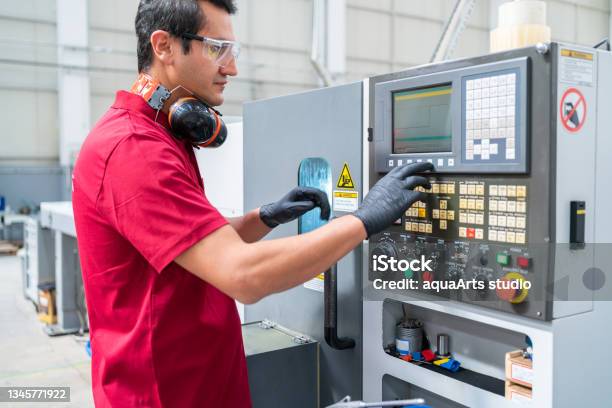 Factory Worker Programming A Cnc Machine Stock Photo - Download Image Now - CNC Machine, Metal Worker, Milling Machine