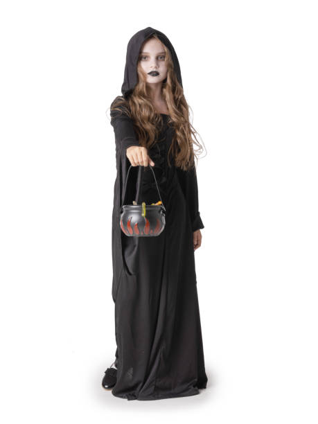 istock Halloween witch girl with cauldron of sweets 1345772734