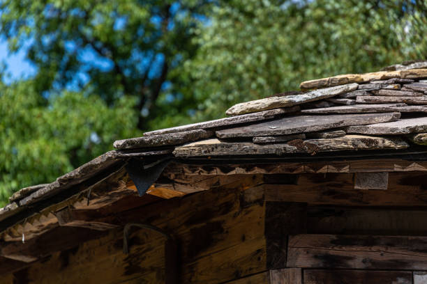 istock Old stone tiles for roof covered with moss 1345777308