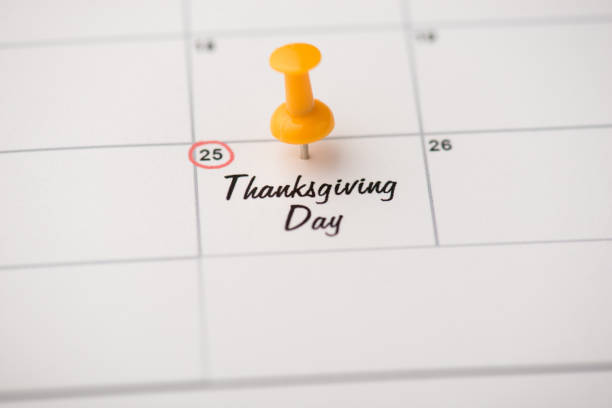 Closeup photo of mark on calendar at twenty-fifth inscription thanksgiving day with yellow pushpin Closeup photo of mark on calendar at twenty-fifth inscription thanksgiving day with yellow pushpin thanksgiving holiday hours stock pictures, royalty-free photos & images