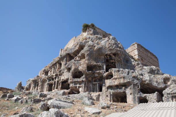 ruins of the ancient town tlos. view of ancient lycian rock tombs date back to 4th century b.c. near the city of fethiye, mugla province, turkey. - mugla province imagens e fotografias de stock