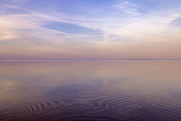 istock Sky background on sunset, colorful clouds. Nature abstract composition with reflections on sea water. Nature environment. 1345796892