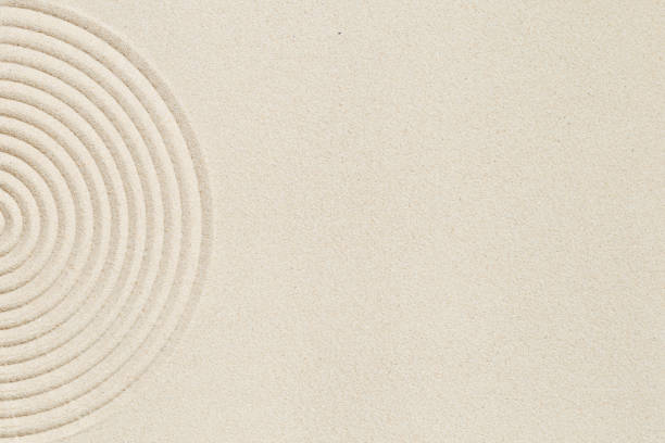 istock Lines drawing on sand, beautiful sandy texture. Spa background, concept for meditation and relaxation 1345796912