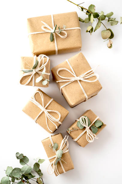 istock Christmas rustic present gift boxes isolated on a white background. Craft paper and eucalyptus leaves. 1345797203