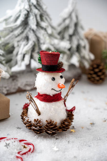 istock Snowman Christmas decoration with gift boxes and fir tree on white background. 1345797274