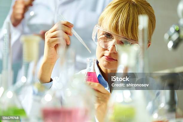 A Scientist Using A Pipette To Add Liquid To A Bottle-foton och fler bilder på Allmänläkare