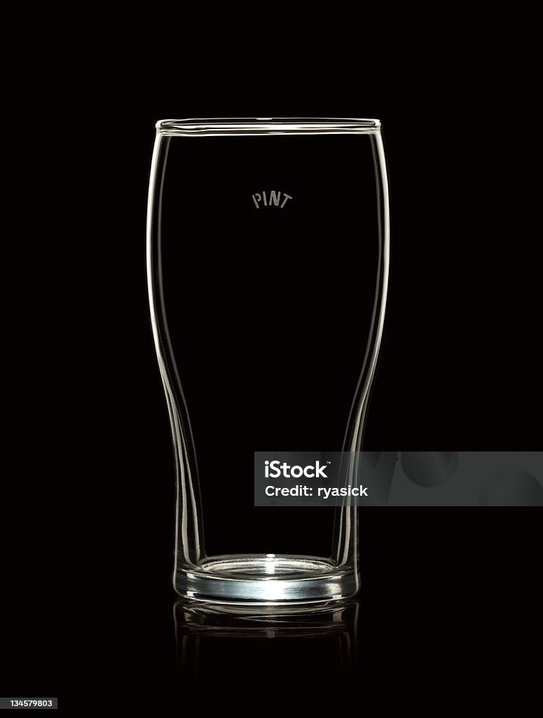 Empty Pint Beer Glass Isolated on Black Background An empty pint glass with reflection is isolated over a black background. It has the word "PINT" printed on the glass near the top - also contains a precise clipping path around glass. Fully cleaned of debris - Canon 5D MarkII. Empty Stock Photo