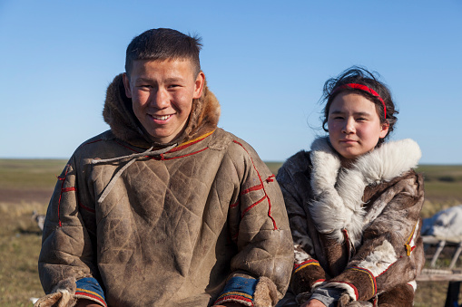 The extreme north, Yamal, the past of Nenets people, the dwelling of the peoples of the north, a family photo near the yurt in the tundra.Nadym, Russia, 06 July 2021