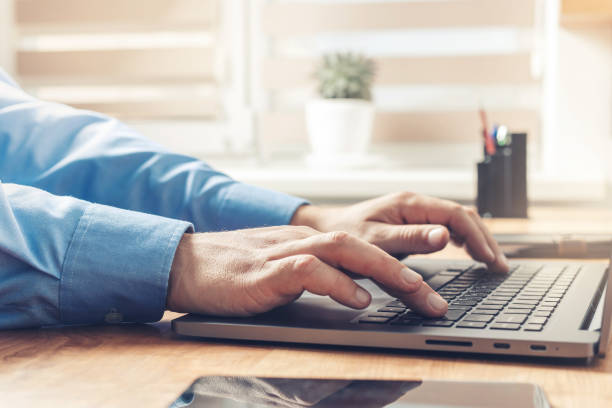 istock Male hands typing on a laptop keyboard, close-up view 1345800447